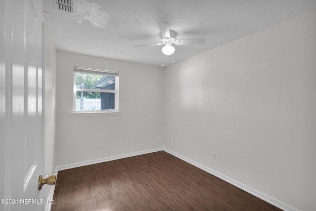 unfurnished room with a textured ceiling, dark hardwood / wood-style flooring, and ceiling fan