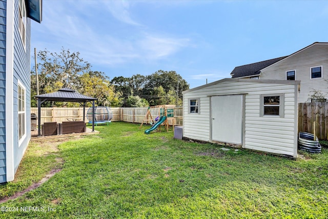 view of yard with a playground, a gazebo, and a storage shed