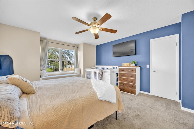 bedroom featuring ceiling fan and light colored carpet