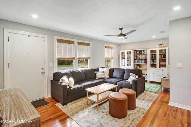 living room featuring ceiling fan and light hardwood / wood-style flooring