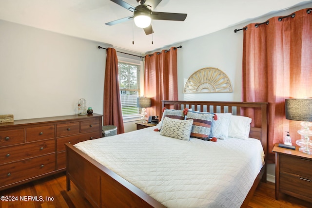 bedroom featuring ceiling fan and dark wood-type flooring