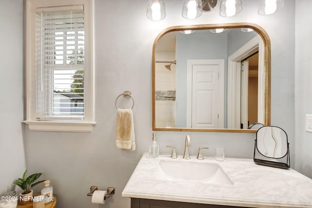 bathroom featuring a shower and vanity