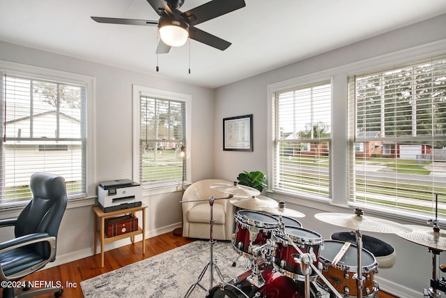 home office featuring ceiling fan and dark wood-type flooring