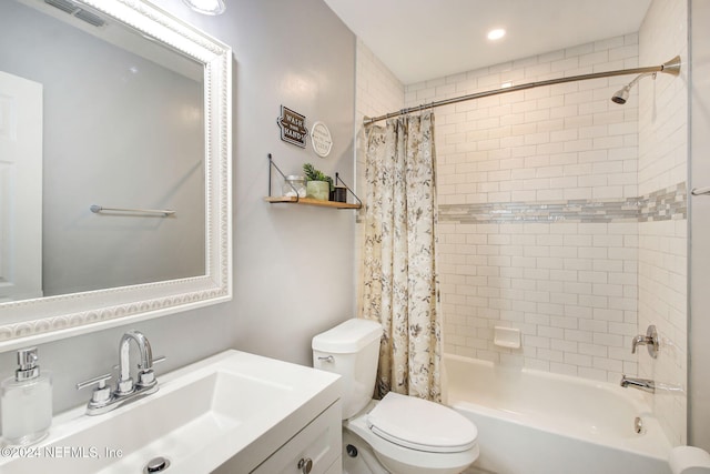 full bathroom with vanity, shower / bath combination with curtain, and toilet