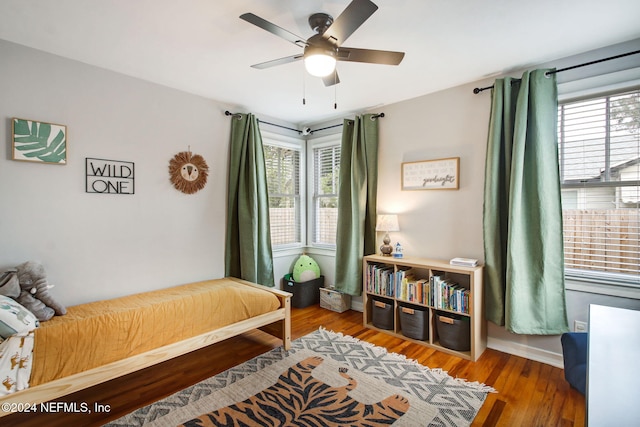 bedroom with ceiling fan and hardwood / wood-style flooring