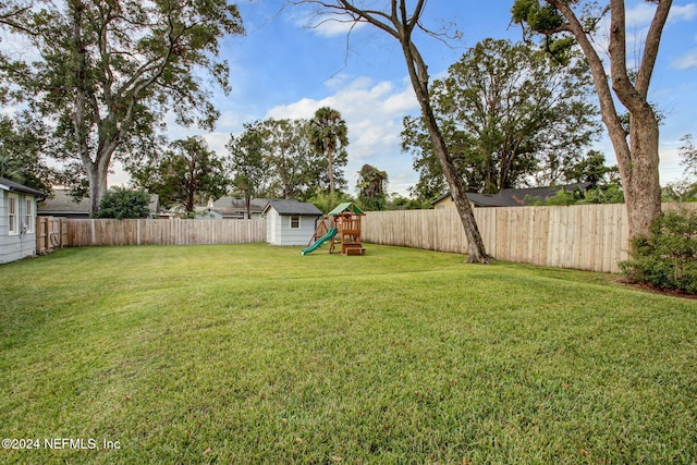 view of yard with a playground and a shed