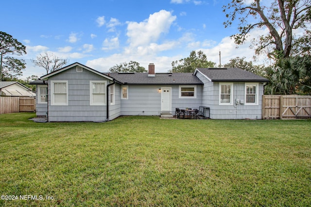 back of house with a yard