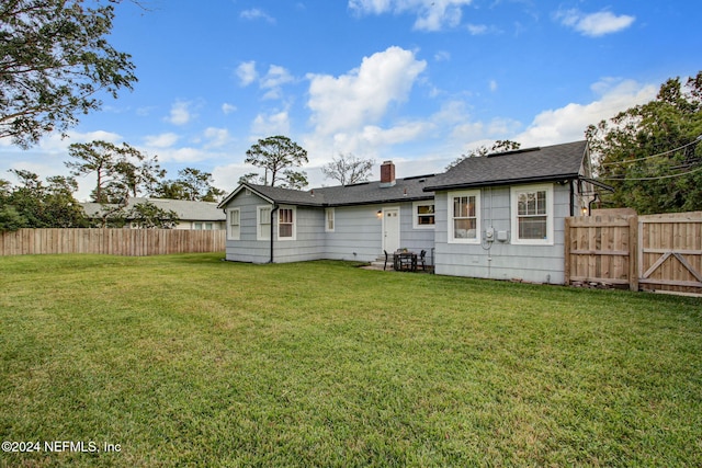 back of house featuring a yard