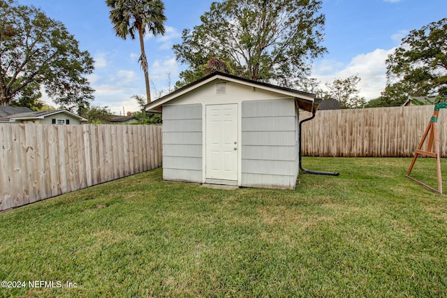 view of outbuilding with a lawn