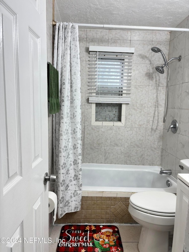 full bathroom featuring tile patterned floors, shower / bathtub combination with curtain, a textured ceiling, and toilet