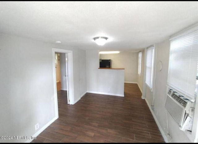 empty room featuring a textured ceiling and dark hardwood / wood-style floors