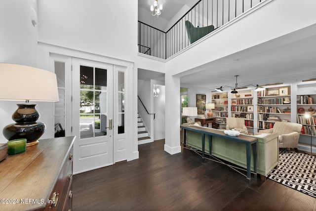 living room with a high ceiling and dark hardwood / wood-style flooring