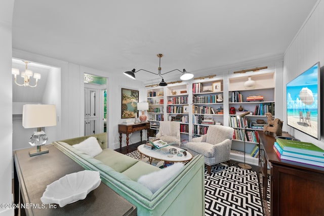 living room featuring built in shelves and a chandelier