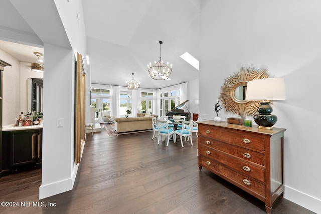 dining space with a chandelier, bar area, and dark hardwood / wood-style flooring