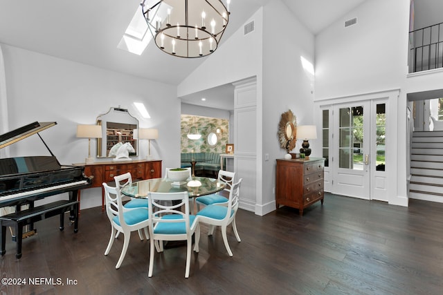 dining space featuring dark hardwood / wood-style floors, high vaulted ceiling, and a chandelier