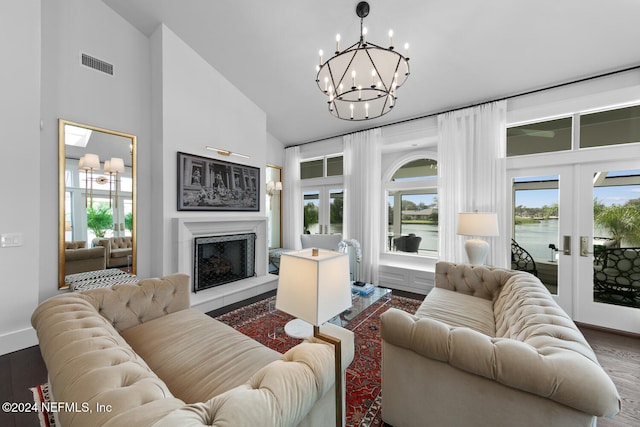 living room with hardwood / wood-style floors, a healthy amount of sunlight, a water view, and french doors