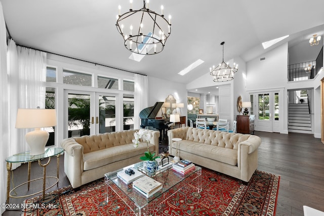 living room with a chandelier, dark hardwood / wood-style flooring, a skylight, and high vaulted ceiling