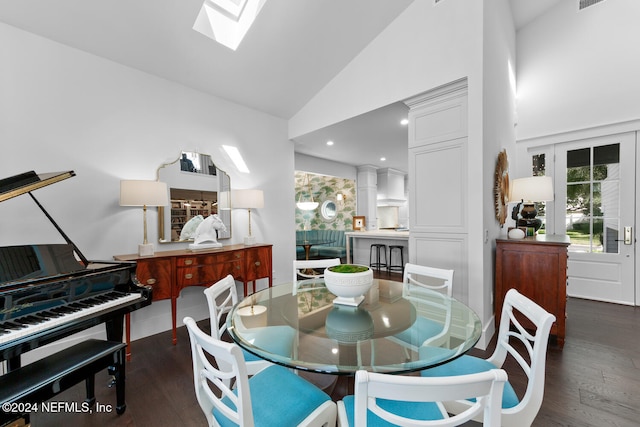 dining room featuring dark hardwood / wood-style flooring and high vaulted ceiling