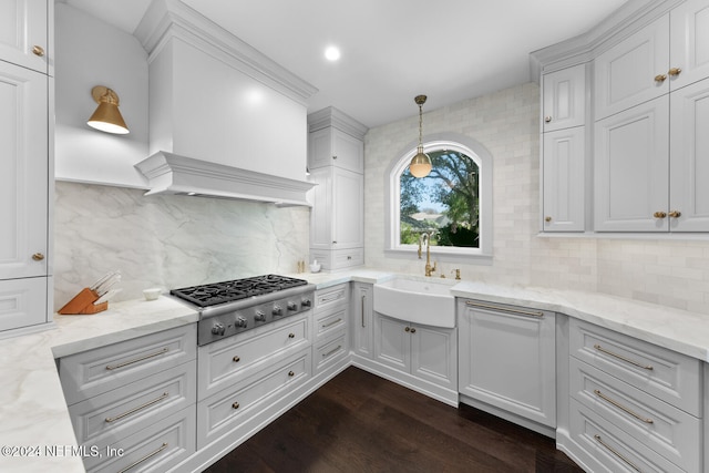 kitchen featuring backsplash, white cabinetry, pendant lighting, and stainless steel gas stovetop