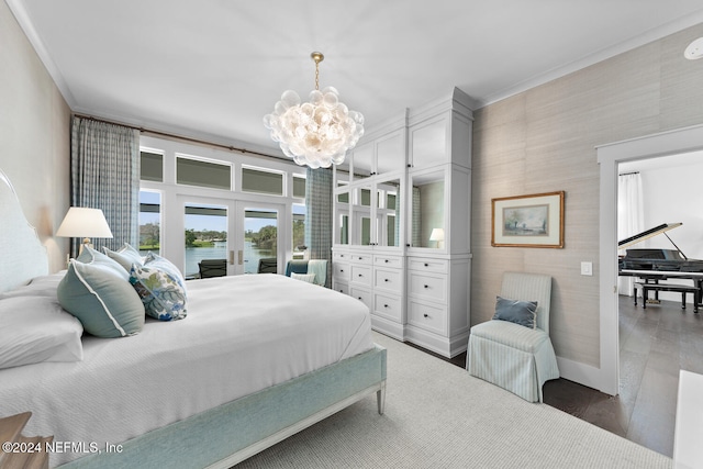 bedroom featuring french doors, ornamental molding, a water view, a chandelier, and dark hardwood / wood-style floors