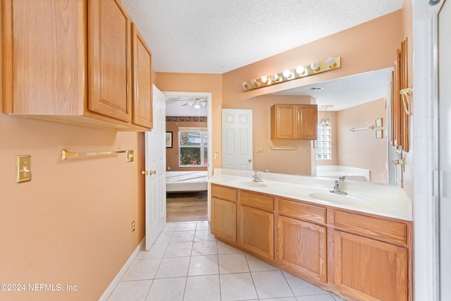 bathroom featuring vanity, a textured ceiling, tile patterned floors, and ceiling fan