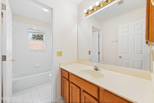 full bathroom with toilet, vanity, tiled shower / bath, and tile patterned flooring