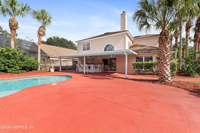 view of swimming pool featuring a lanai and a patio