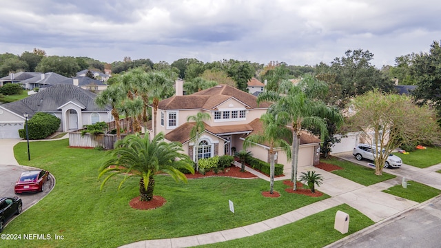 view of front of property with a garage and a front lawn