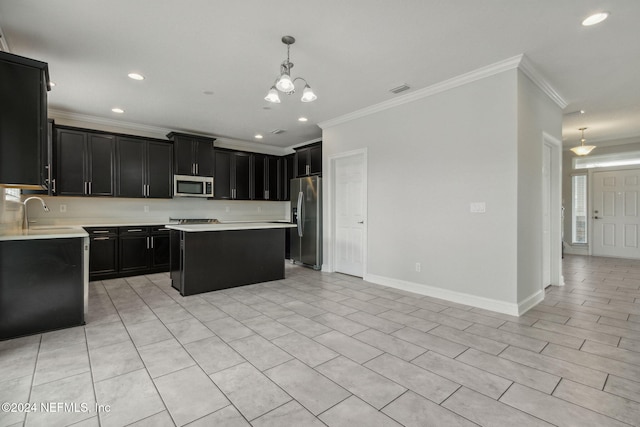 kitchen featuring stainless steel appliances, a center island, sink, crown molding, and decorative light fixtures