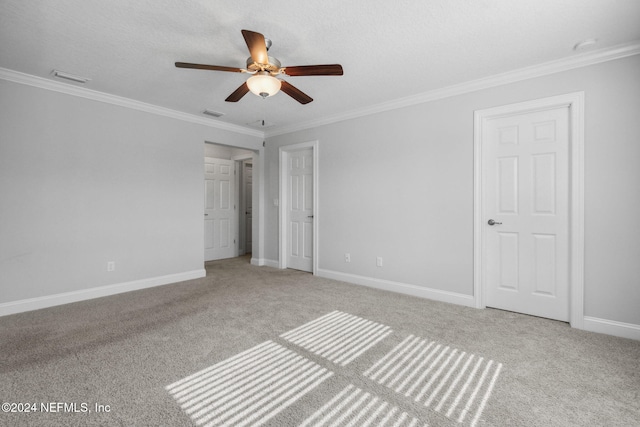 unfurnished bedroom featuring a textured ceiling, light carpet, ceiling fan, and crown molding