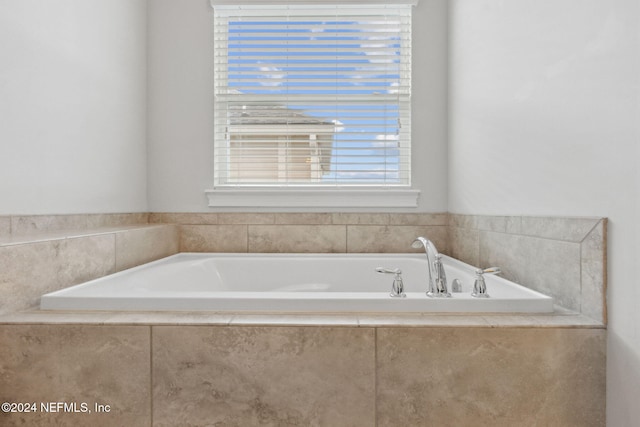 bathroom with tiled bath