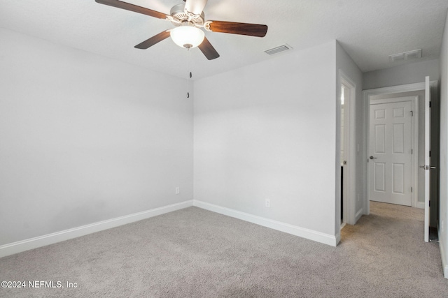 unfurnished room featuring light colored carpet and ceiling fan