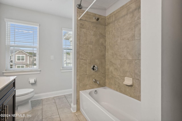 full bathroom with vanity, a healthy amount of sunlight, tile patterned floors, and tiled shower / bath