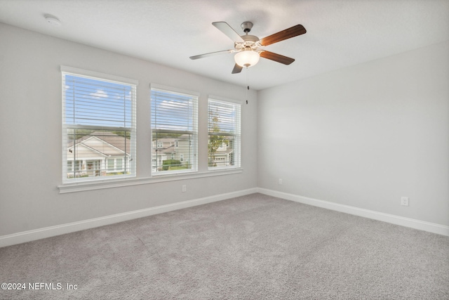 carpeted empty room with plenty of natural light and ceiling fan