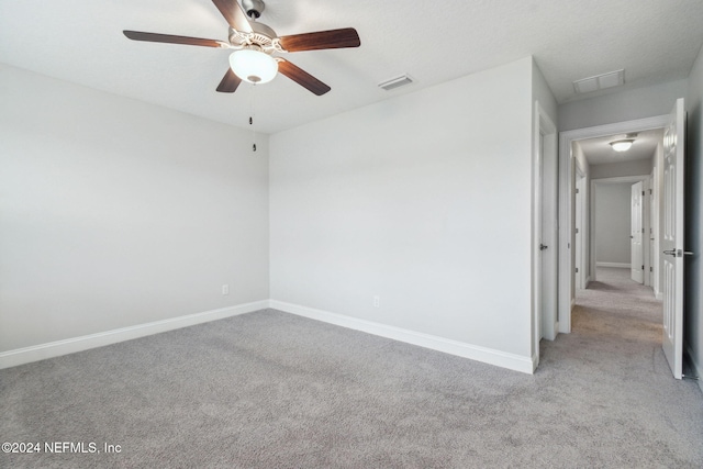 empty room with ceiling fan and light colored carpet