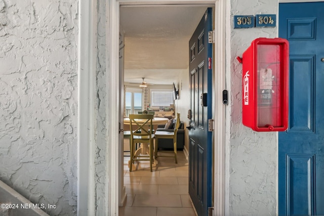 413 1st St S Unit 303, Jacksonville Beach, FL 32250 - hall with tile patterned flooring and a textured ceiling