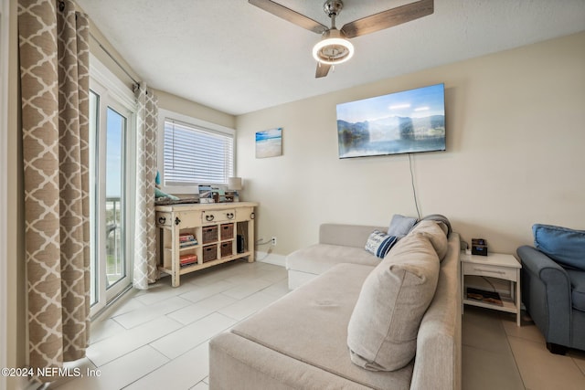 413 1st St S Unit 303, Jacksonville Beach, FL 32250 - tiled living room with a textured ceiling and ceiling fan