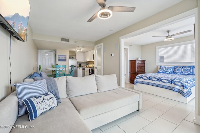 413 1st St S Unit 303, Jacksonville Beach, FL 32250 - tiled bedroom featuring ceiling fan and stainless steel refrigerator