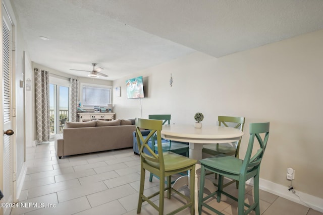 413 1st St S Unit 303, Jacksonville Beach, FL 32250 - dining area with light tile patterned flooring, ceiling fan, and a textured ceiling