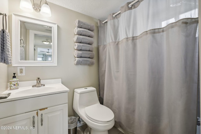 413 1st St S Unit 303, Jacksonville Beach, FL 32250 - bathroom featuring curtained shower, vanity, a textured ceiling, and toilet