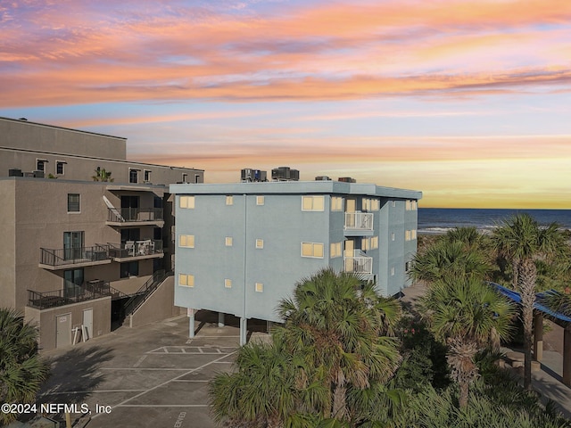 413 1st St S Unit 303, Jacksonville Beach, FL 32250 - outdoor building at dusk featuring a water view
