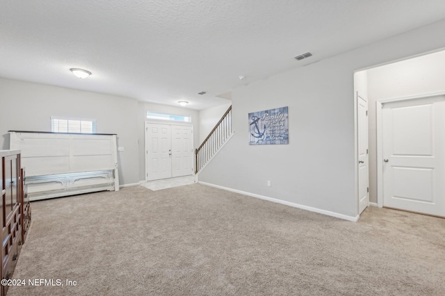 carpeted bedroom with a textured ceiling