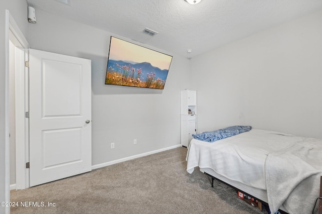 carpeted bedroom with a textured ceiling