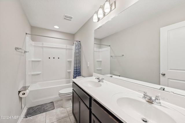 full bathroom with shower / bath combination with curtain, vanity, a textured ceiling, tile patterned flooring, and toilet