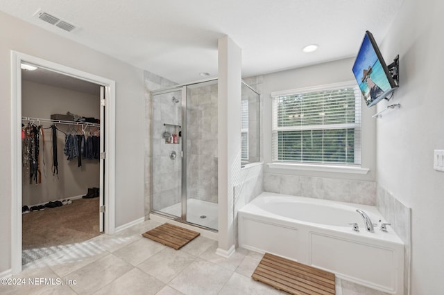 bathroom with tile patterned floors and separate shower and tub