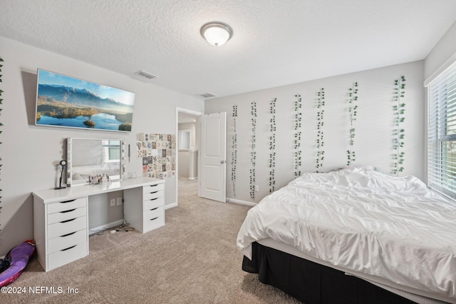 carpeted bedroom featuring a textured ceiling