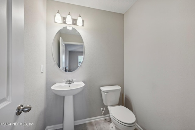 bathroom featuring wood-type flooring and toilet