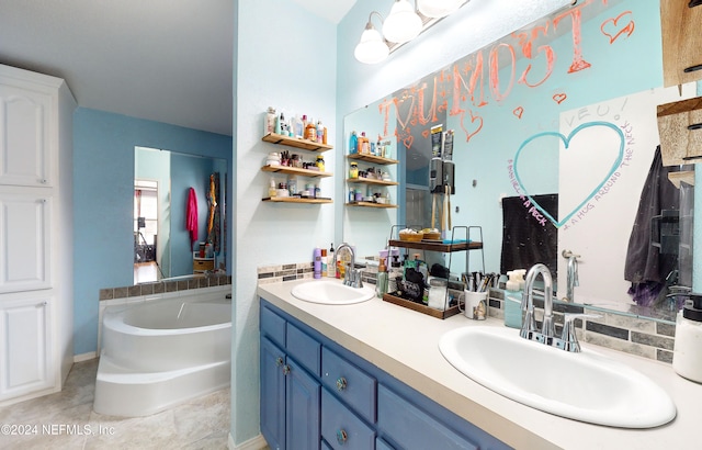 bathroom with vanity, a washtub, and tile patterned floors