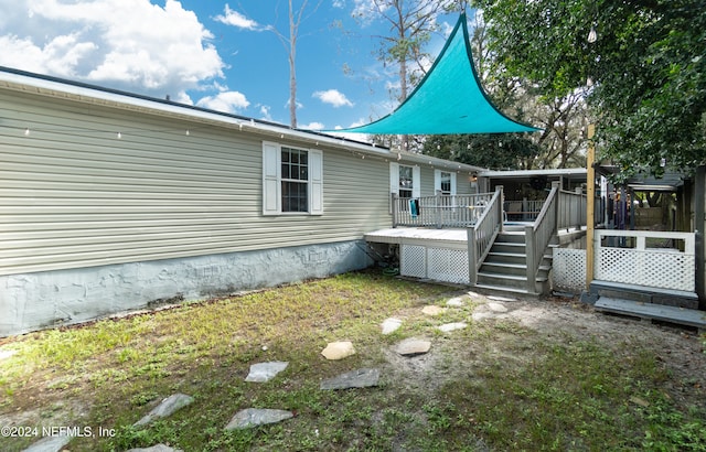 back of property featuring a deck