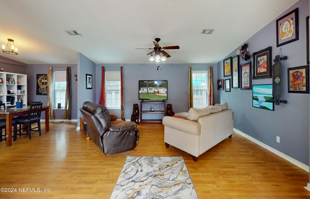 living room with ceiling fan and light hardwood / wood-style flooring